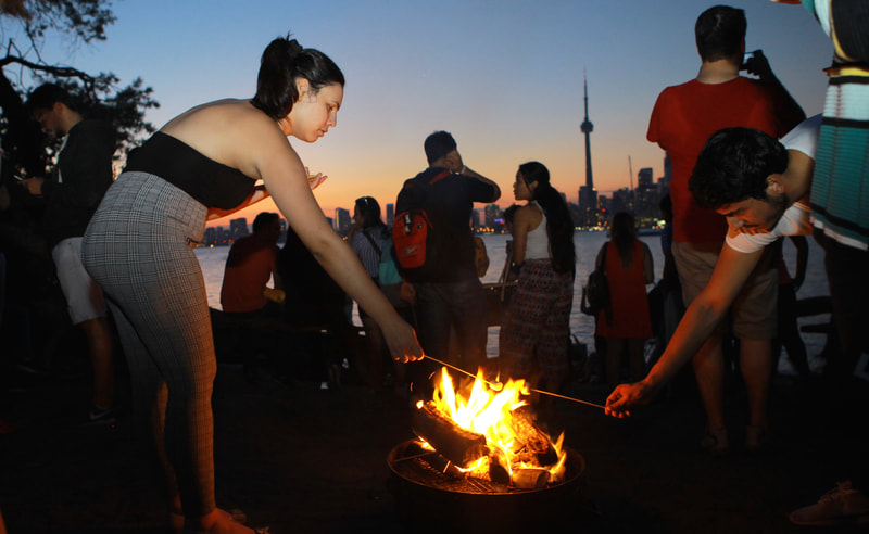 the toronto islands are open through out the year for outdoors activity such as bonfire at a fire pit